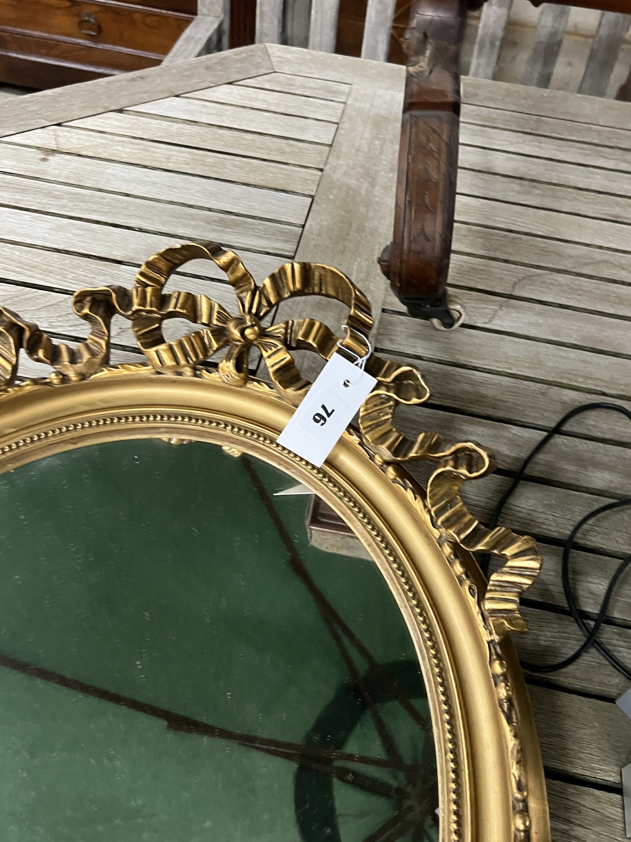 A pair of Victorian style gilt and composition oval mirrors, width 48cm, height 65cm